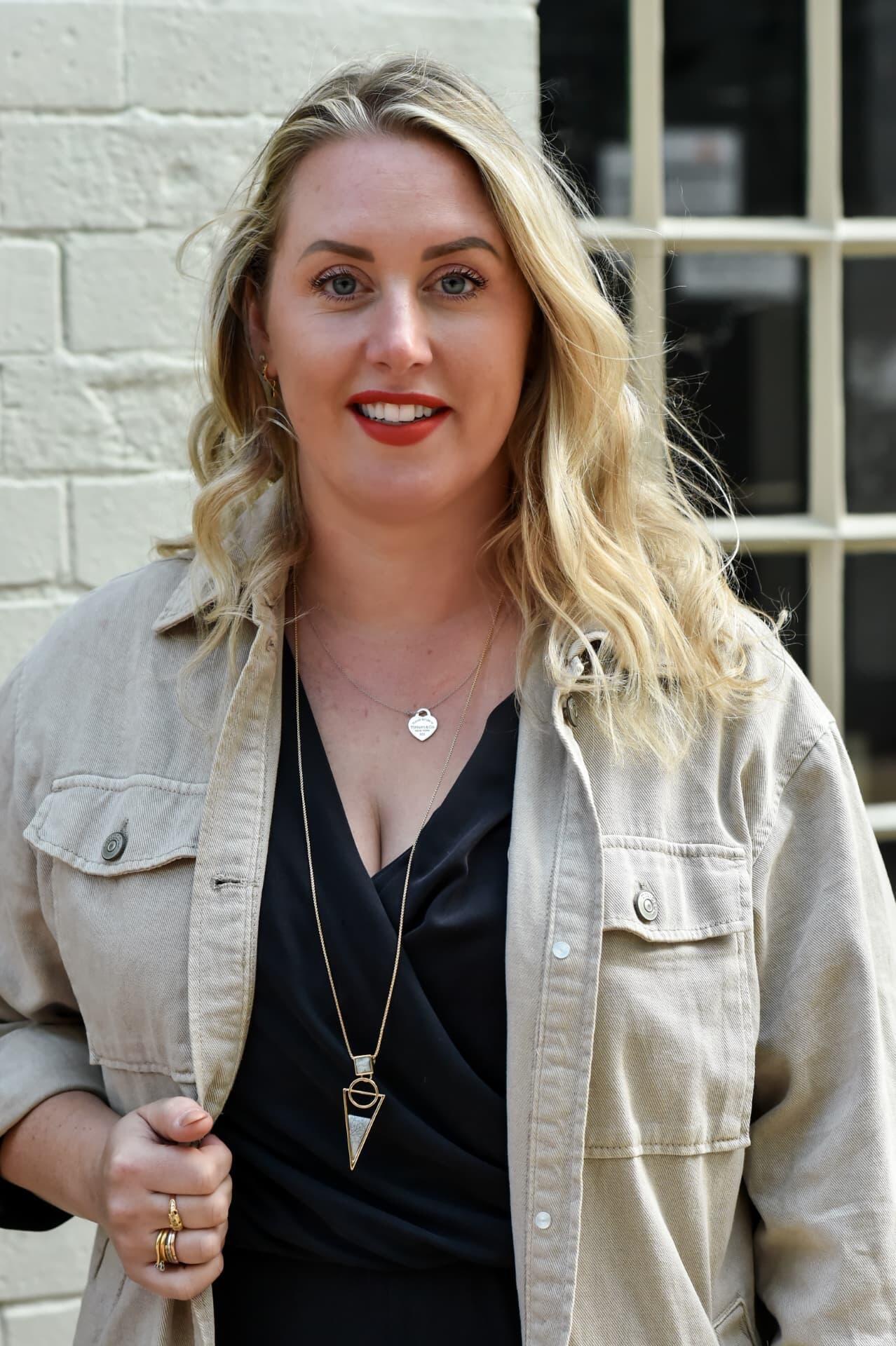 Headshot of Emma Fishlock in a beige jacket.