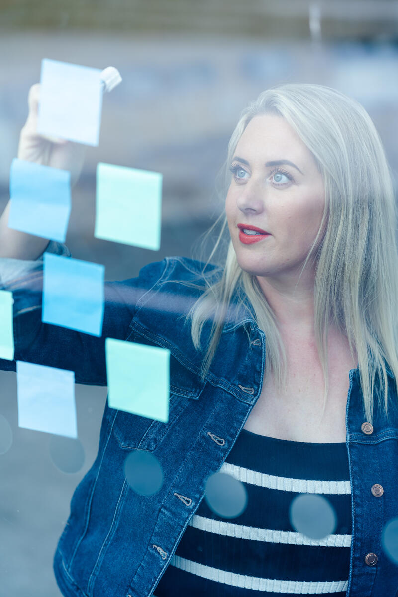 Strategy session with sticky notes on a glass board